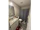 Charming bathroom with granite countertop, decorative shower curtain and gray vinyl flooring at 1017 W C St, Kannapolis, NC 28081