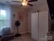 Bright bedroom featuring a window, ceiling fan, and ample storage with a clean and inviting atmosphere at 1017 W C St, Kannapolis, NC 28081