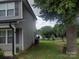 Side view of the house with neat landscaping and a view of the backyard at 1017 W C St, Kannapolis, NC 28081