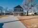 Charming two-story home with a gray exterior, well-manicured lawn, and a concrete driveway on a sunny day at 1017 W C St, Kannapolis, NC 28081