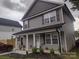 Charming two-story home with a covered front porch and well-maintained landscaping at 1017 W C St, Kannapolis, NC 28081