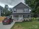 Charming two-story home with a covered front porch and well-maintained landscaping at 1017 W C St, Kannapolis, NC 28081