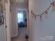 Hallway view showcasing neutral walls, modern decor, and an open doorway leading to a bedroom at 1017 W C St, Kannapolis, NC 28081