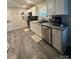 Well-equipped kitchen with wood floors, white cabinetry, and stainless steel appliances at 1017 W C St, Kannapolis, NC 28081