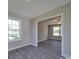 Open-concept living area with stylish gray flooring, a ceiling fan, and lots of natural light at 1017 W C St, Kannapolis, NC 28081