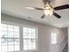 Bright living room with a ceiling fan and stairs to the second level at 1017 W C St, Kannapolis, NC 28081
