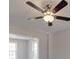 A bright living room featuring a ceiling fan and ample natural light from large windows at 1017 W C St, Kannapolis, NC 28081