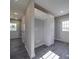 A well-lit room with gray plank flooring, white trim, doors and cabinets at 1017 W C St, Kannapolis, NC 28081