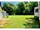 Expansive backyard with lush green grass, mature trees, and a sunny disposition at 1020 N Ransom St, Gastonia, NC 28052