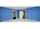 Vibrant bedroom boasts marble floors, blue walls, and well-lit closets, offering spacious comfort at 1020 N Ransom St, Gastonia, NC 28052