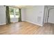 Bright bedroom featuring wood flooring, a window and base molding at 1020 N Ransom St, Gastonia, NC 28052