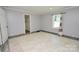 Neutral bedroom boasting tile floors, a walk-in closet, fresh paint, and a sunny window at 1020 N Ransom St, Gastonia, NC 28052