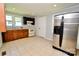 Bright kitchen with a stainless refrigerator, white appliances, and updated countertops at 1020 N Ransom St, Gastonia, NC 28052