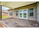Covered back porch with wooden deck and exposed brick at 116 Postell Dr, Statesville, NC 28625