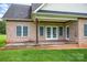 Covered back porch with wooden deck and brick support columns at 116 Postell Dr, Statesville, NC 28625
