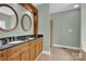 Bathroom featuring a double sink vanity, granite countertop, and walk-in shower at 116 Postell Dr, Statesville, NC 28625