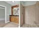 Bathroom showcasing a double sink vanity, walk-in shower, and neutral tile at 116 Postell Dr, Statesville, NC 28625