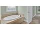 Bathroom showing a large soaking tub, mosaic tile, and a neutral color palette at 116 Postell Dr, Statesville, NC 28625