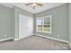 Bedroom features a large window, neutral paint, and a double door closet at 116 Postell Dr, Statesville, NC 28625