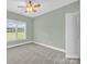 Bright bedroom with a ceiling fan, a large window, and neutral carpet at 116 Postell Dr, Statesville, NC 28625