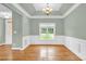 Traditional dining room featuring hardwood floors, tray ceiling, and wainscoting at 116 Postell Dr, Statesville, NC 28625