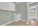 Laundry room showing a single bowl sink, white cabinets, and neutral paint at 116 Postell Dr, Statesville, NC 28625