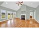 Bright living room featuring a fireplace, hardwood floors, and access to the backyard at 116 Postell Dr, Statesville, NC 28625