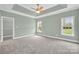 Spacious main bedroom with a tray ceiling, two windows and neutral carpeting at 116 Postell Dr, Statesville, NC 28625