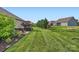 Expansive backyard featuring lush green grass, a cozy patio with seating, and well-maintained landscaping at 125 Rosebay Dr, Mooresville, NC 28117