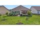 Beautifully landscaped backyard with a patio, mature trees, and a spacious lawn for outdoor enjoyment at 125 Rosebay Dr, Mooresville, NC 28117