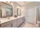 Bright bathroom featuring double vanity with granite countertop and decorative mirrors at 125 Rosebay Dr, Mooresville, NC 28117