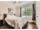 Cozy bedroom with hardwood floors, a ceiling fan, and a large window with natural light at 125 Rosebay Dr, Mooresville, NC 28117
