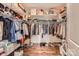 Spacious walk-in closet with custom shelving, hardwood floors, and ample storage at 125 Rosebay Dr, Mooresville, NC 28117