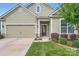 Charming home featuring a welcoming front porch, well-manicured lawn, and an attached garage, creating curb appeal at 125 Rosebay Dr, Mooresville, NC 28117