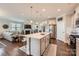 Open concept kitchen with a large center island, stainless appliances, and hardwood floors at 125 Rosebay Dr, Mooresville, NC 28117