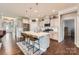 Stylish kitchen featuring white cabinets, stainless steel appliances, and an island with bar seating at 125 Rosebay Dr, Mooresville, NC 28117