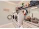 Functional laundry room featuring modern washer and dryer, granite countertop and shelving at 125 Rosebay Dr, Mooresville, NC 28117