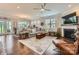 Open-concept living room with a fireplace, hardwood floors, and comfortable seating at 125 Rosebay Dr, Mooresville, NC 28117