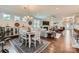 Bright living room with hardwood floors, dining area, comfortable seating and fireplace at 125 Rosebay Dr, Mooresville, NC 28117
