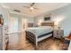 Main bedroom featuring hardwood floors, a ceiling fan, and an ensuite bathroom at 125 Rosebay Dr, Mooresville, NC 28117