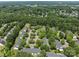 Aerial community view shows dense tree coverage, planned parking, and well-spaced townhome buildings at 12516 Hennigan Place Ln, Charlotte, NC 28214