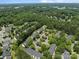 Wooded community aerial featuring townhome clusters, parking, and lush tree canopy around the property at 12516 Hennigan Place Ln, Charlotte, NC 28214