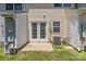 Back patio showcasing french doors, AC unit, window, and a cozy outdoor space at 12516 Hennigan Place Ln, Charlotte, NC 28214