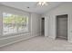 Bedroom with window views, a fan, and closet storage at 12516 Hennigan Place Ln, Charlotte, NC 28214
