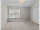 Bedroom featuring neutral tones, a window letting in natural light and closet space at 12516 Hennigan Place Ln, Charlotte, NC 28214