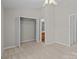 Bedroom featuring neutral walls, plush carpet, open closet, and ensuite bathroom access at 12516 Hennigan Place Ln, Charlotte, NC 28214
