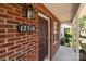 Close-up of front entrance showing a dark wooden door and house number on a brick facade at 12516 Hennigan Place Ln, Charlotte, NC 28214