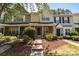 Charming townhouse with brick accents, manicured landscaping, and inviting front porch at 12516 Hennigan Place Ln, Charlotte, NC 28214