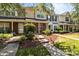 Townhouse exterior with inviting walkway, manicured shrubbery, and well-maintained facade at 12516 Hennigan Place Ln, Charlotte, NC 28214