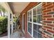 A view of the front porch with a brick facade, covered porch, and 'HOME' welcome mat at 12516 Hennigan Place Ln, Charlotte, NC 28214